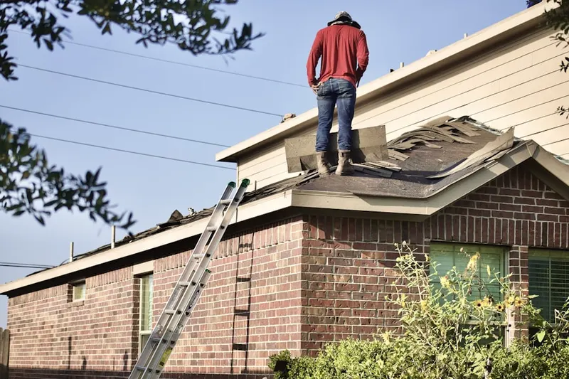 Professional roofer working on a residential roof in Pigeye